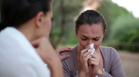Female friend comforting sad woman, outdoor Stock Footage