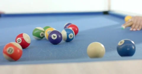 Female friends breaking rack on pool table at home after placing cue ball to Stock Footage 340968909