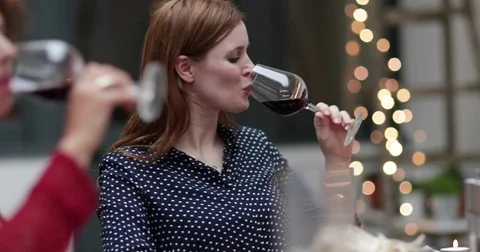 Female friends drinking red wine Stock Footage
