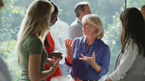 Female friends or casual business colleagues chatting together at a social event Stock Footage
