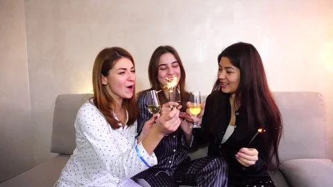Female friends spend time and gossip with alcohol and bengal lights Stock Footage
