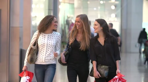 Female Friends Walking Through Shopping Mall In Slow Motion Stock Footage