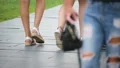 Female friends walking together in park, spending time outdoors, legs closeup HD Footage