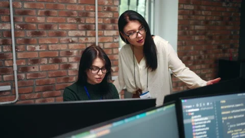 Female front-end developer and data scientists working in office of IT-company Stock Footage 233718136