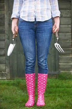 Female Gardener Holding Trowel And Fork Stock Photos