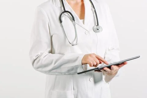 Female general medical practitioner using tablet computer Stock Photos