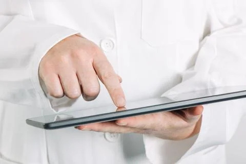 Female general medical practitioner using tablet computer Stock Photos