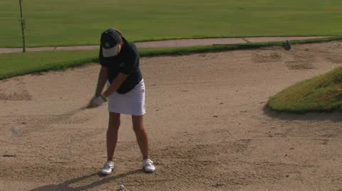 Female golfer in sand pit Stock Footage 24978083