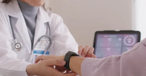 Female GP practitioner share how to use medical accessories smartwatch Stock Footage 197918251