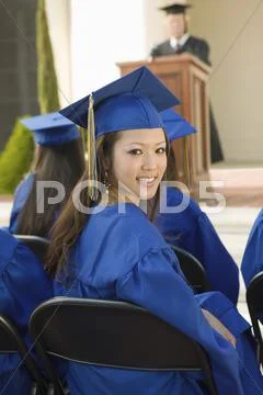 Female Graduate With Friends Attending Graduation Ceremony Stock Photos
