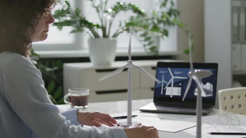 Female Green Energy Engineer Analyzing Wind Turbine Model in Office Stock Footage 314838844