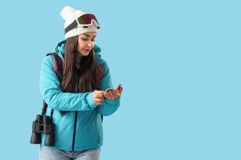 Female guide with compass on blue background Stock Photos