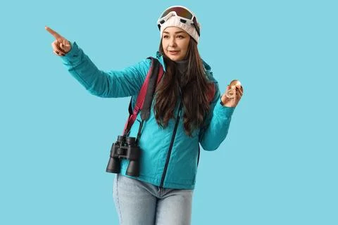 Female guide with compass pointing at something on blue background Stock Photos