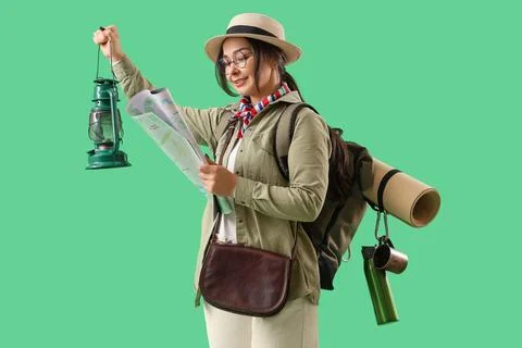 Female guide with map and lantern on green background Stock Photos