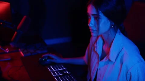 Female hacker coding in a dark room with neon lights Stock Footage 344392178