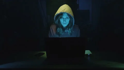 Female Hacker In Hoodie Jacket Coding And Developing Malware On A Laptop Stock Footage 166496442