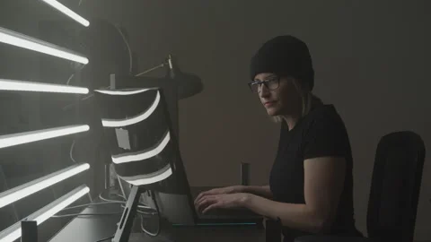 Female Hacker Typing on Her Computer in Her Basement Stock Footage 208725294