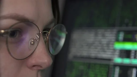 A female hacker works at a computer at night in the dark. Stock Footage 168875568