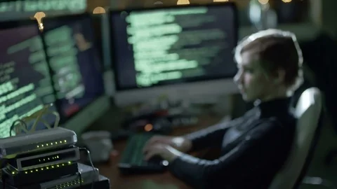 Female Hacker Writing Computer Code in Dark Office Stock Footage 81537210