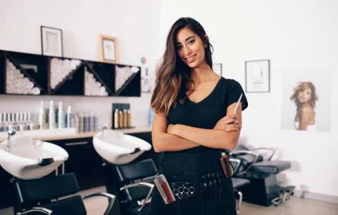 Female hairdresser standing in salon Stock Photos