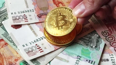 Female hand adding a Bitcoin coin to a stack of coins Stock Footage 281372487