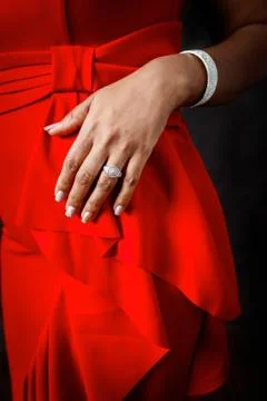 Female hand against a red dress Stock Photos