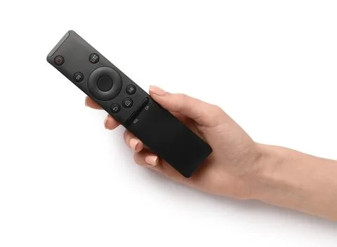 Female hand with black remote controller on white background 库存照片