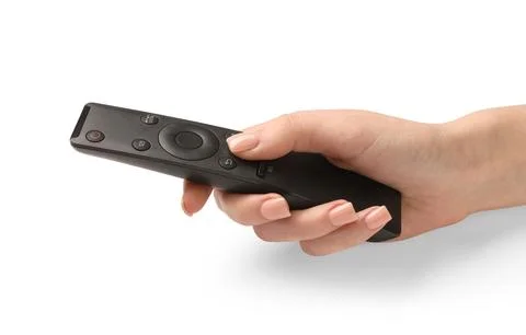 Female hand with black remote controller on white background 库存照片