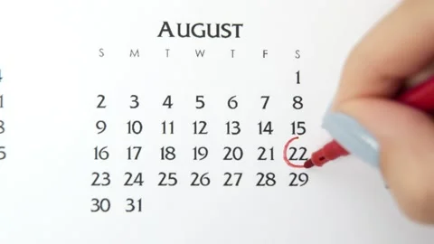 Female hand circle day in calendar date with a red marker. Business Basics Wall Stock Footage 143529341