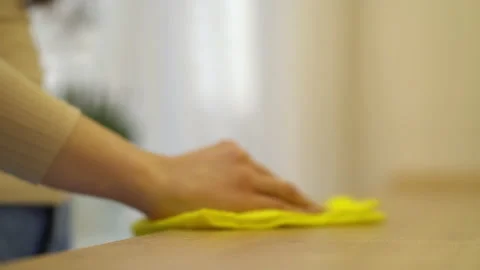 Female hand cleaning kitchen table with yellow disinfecting wipe. Stock Footage 148372492