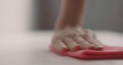 Female hand cleans table surface by pink rag. Slow motion Stock Footage 153000112