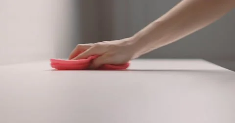 Female hand cleans table surface by pink rag. Slow motion Stock Footage 153043438