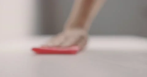 Female hand cleans table surface by pink rag. Slow motion Stock Footage 153043592