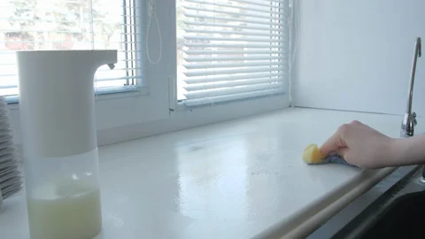 Female hand cleans window sill with cleaning agent Stock Footage 129332014