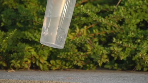 Female hand with a clever clock puts a sports shaker on the parapet in the park Video stock 92572602