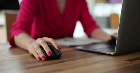 Female hand clicks computer mouse at modern office wooden desk Stock Footage 312933381