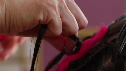 Female hand close up. Process of braiding pink African braids Stock Footage 319964306