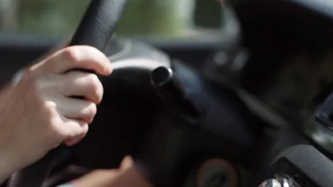 Female hand close-up on the steering wheel of a car. A woman is driving Stock Footage