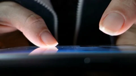 Female hand closeup leafing through video on the phone. Video stock 100599589