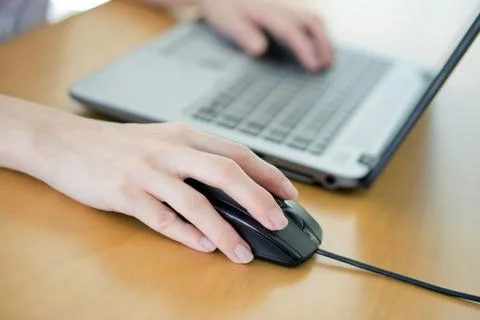 Female hand with computer mouse on table, closeup Stock Photos