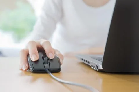 Female hand with computer mouse on table, closeup Stock Photos
