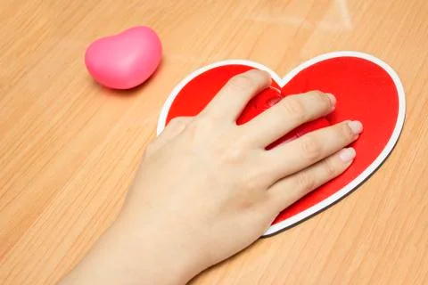 Female hand with computer mouse on table.valentine day Stock Photos