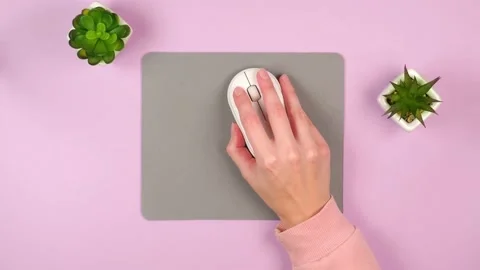 A female hand controls a white computer mouse clicks Stock Footage 165266657