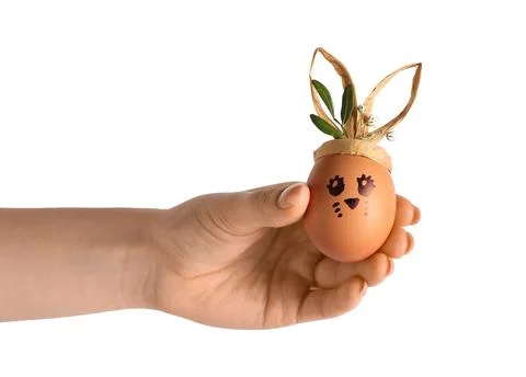 Female hand with creative Easter egg on white background Stock Photos