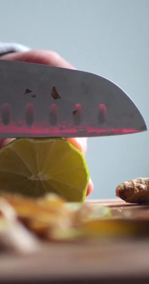 Female Hand Cuts Lime with a Knife on a Board for Making Lemonade... Stock Footage 344454661