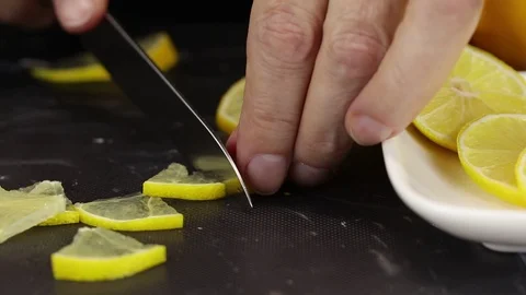Female hand cuts a slice of lemon Stock Footage 123016519