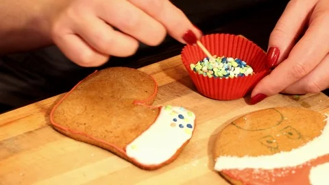 Female hand decorates gingerbread, close-up Stock Footage 107337826