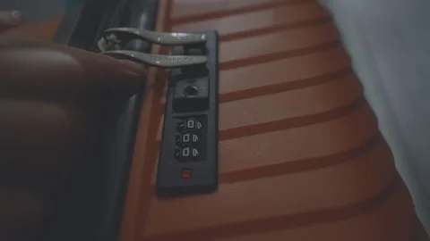 Female hand dials security code number on suitcase lock of luggage Stock Footage 252039443
