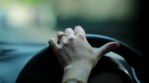 Female hand driver behind the wheel of a car, closeup. view of woman driving. Stock-Footage 336265463