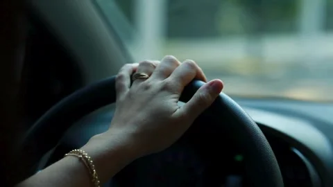 Female hand driver behind the wheel of a car, closeup. view of woman driving. Stock-Footage 336265481